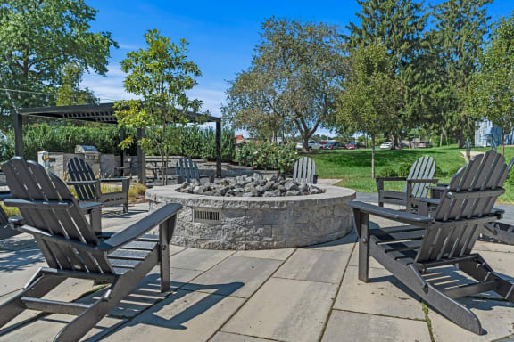 an outdoor patio with chairs and a fire pit at Chestnut Hill Village, Philadelphia, PA