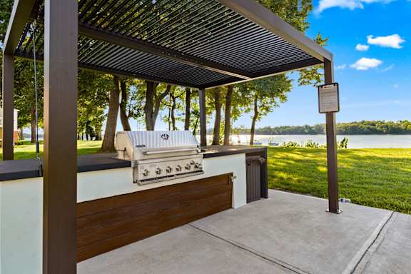 A grill is on a table under a roof.