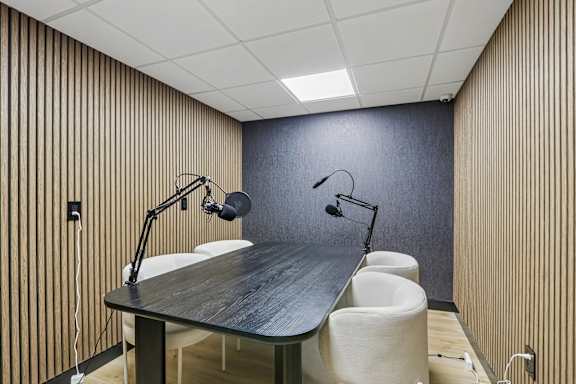 A conference room with a long table and chairs.