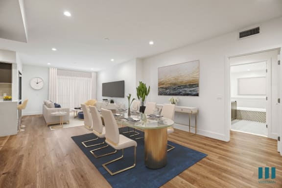 a living room with white walls and a table with chairs