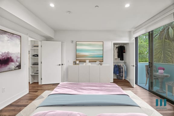 a bedroom with a bed and a chair in a 555 waverly unit