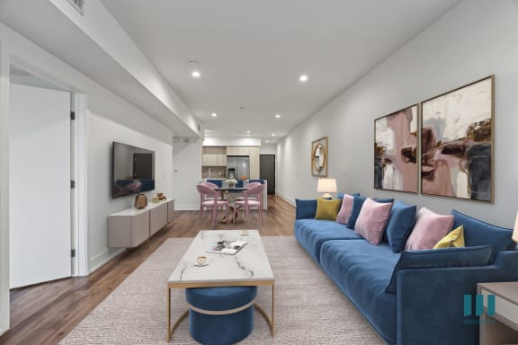 a living room with a blue couch and a coffee table