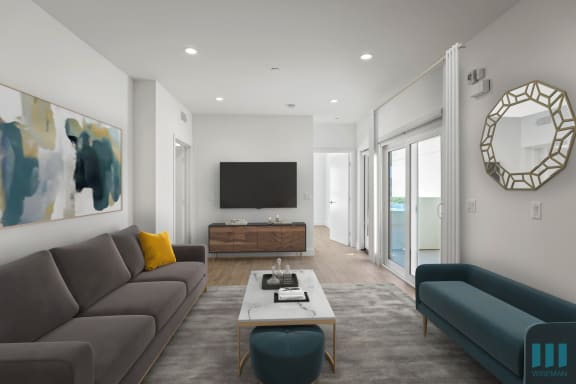 a living room with couches and a coffee table in front of a flat screen tv