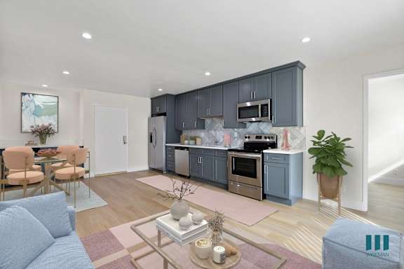 a kitchen with gray cabinets and white countertops