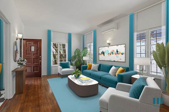 a living room with a blue couch and a table with yellow chairs