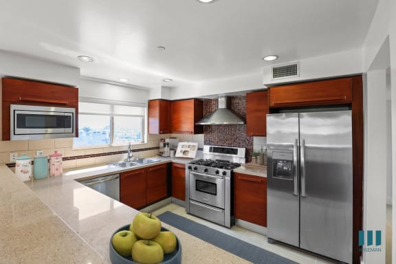 a kitchen with stainless steel appliances and granite counter tops