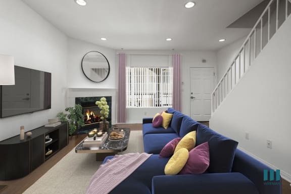 a living room with a fireplace and a dining room in the background