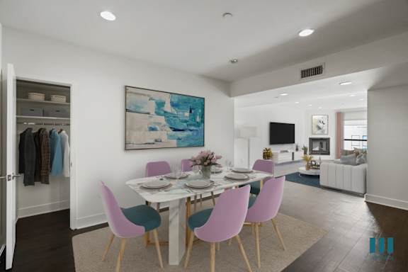 a living room with a fireplace and a dining room in the background