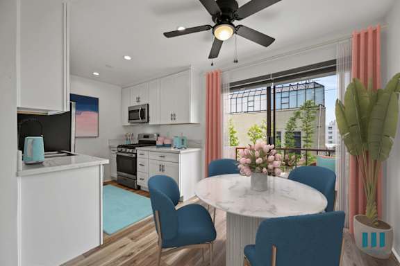 a living room with a blue couch and a table with yellow chairs