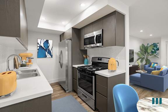 A modern kitchen with a blue chair and a yellow kettle.