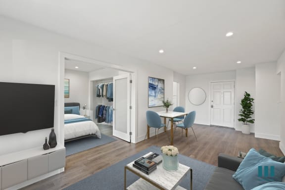 a living room with a couch and a table  and a bed