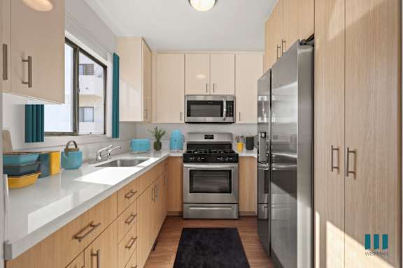a kitchen with stainless steel appliances and white cabinets