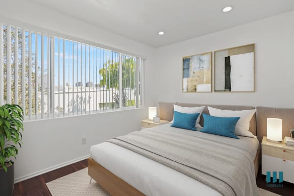 a bedroom with a bed and a large window