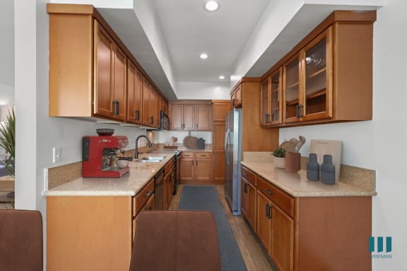 a kitchen with gray cabinets and white countertops