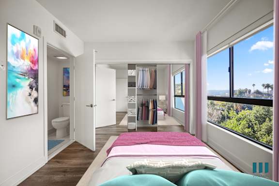 A bedroom with a large bed and a view of the ocean.