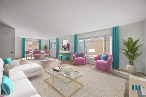 a living room with a blue couch and a table with yellow chairs