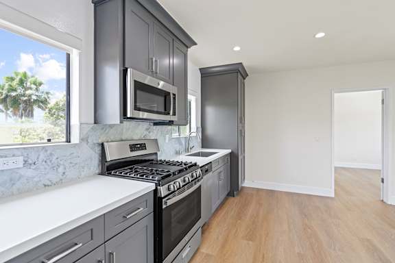Kitchen with Natural Window Light, Extra Cabinet Storage, and Stainless Steel Appliances
