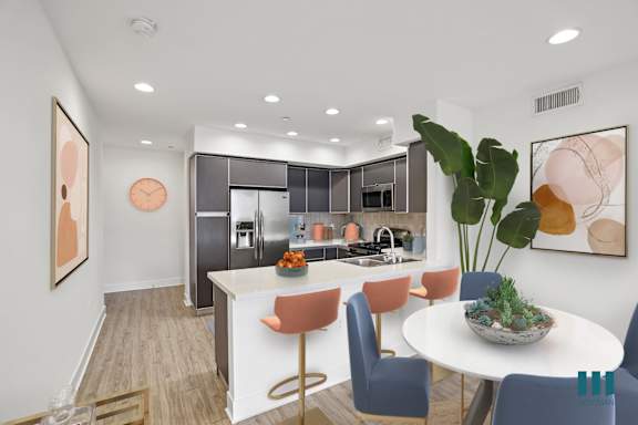 a dining area with yellow chairs and a round dining table
