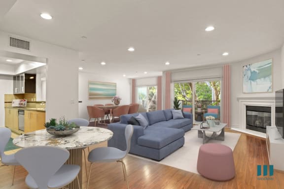a living room with a blue couch and a table with yellow chairs