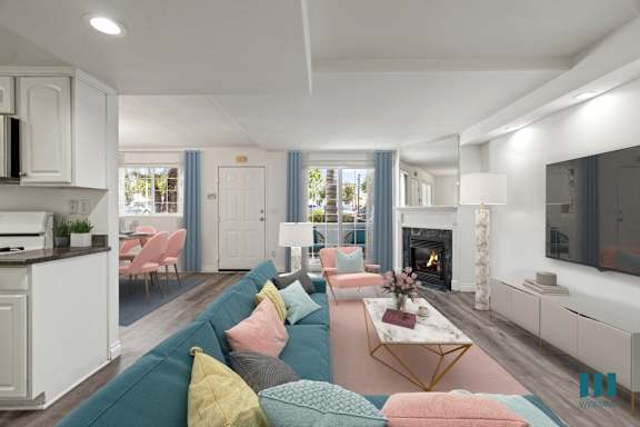 A modern living room with a fireplace and a kitchen area.