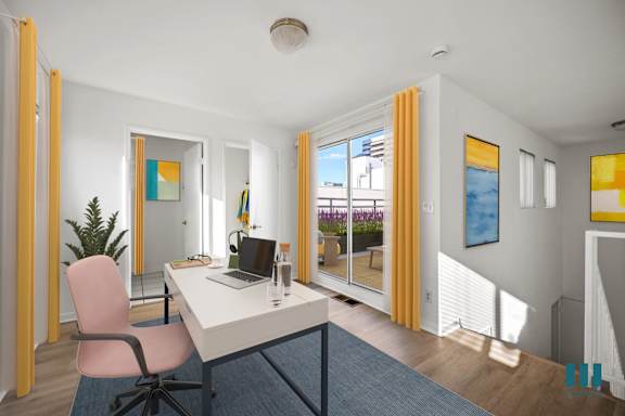 a living room with a blue couch and a table with yellow chairs