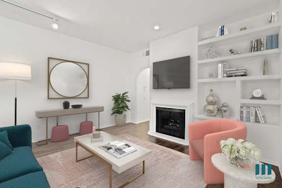 a living room with a couch and chairs and a table