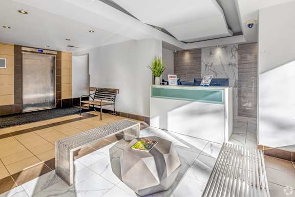 A gym with a variety of equipment including treadmills, weights, and exercise machines.