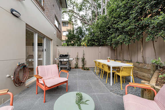 A patio with a table and chairs.