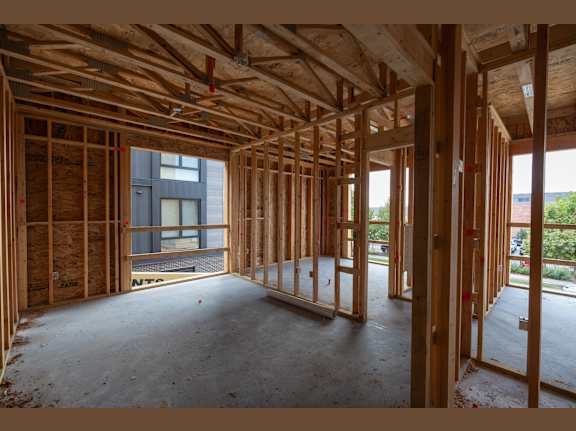 A room under construction with wooden beams and no walls.