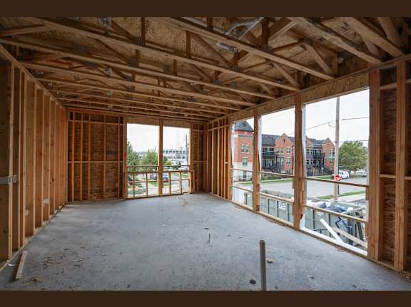 A room under construction with wooden beams and no walls.