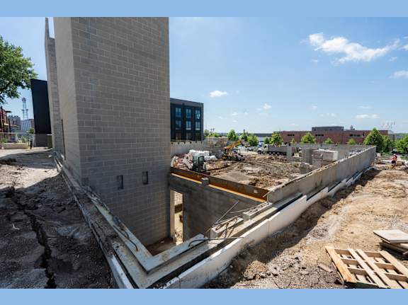 A construction site with a large concrete structure under construction.