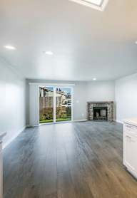 A modern kitchen with white cabinets and a stainless steel dishwasher.