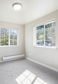 A room with a window and a bench.