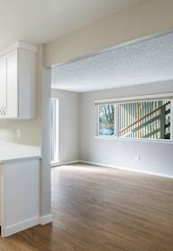 A kitchen with white cabinets and a stainless steel dishwasher.