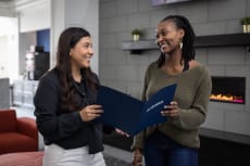 two women looking at an open book