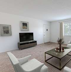 a living room with white furniture and a flat screen tv