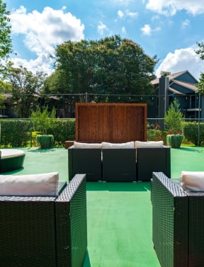 an outdoor seating area with chairs and umbrellas