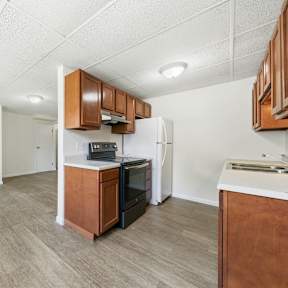 A room with a carpeted floor and a white wall.