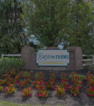 the sign at the entrance to bath farms with flowers