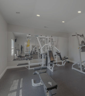 a gym with treadmills and other exercise equipment in a home
