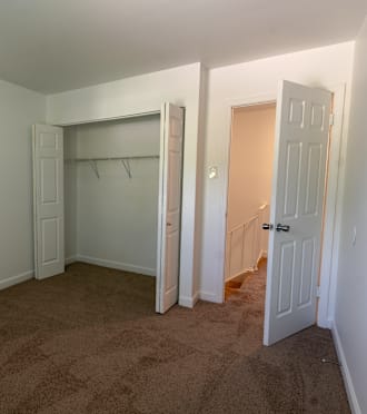 a bedroom with a closet and a door to a closet