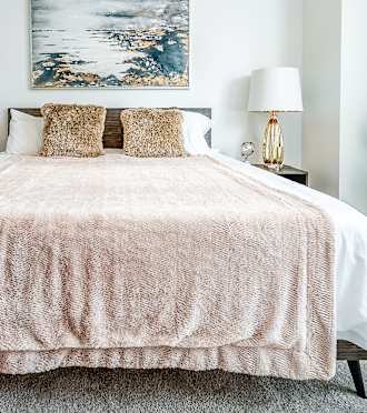 a bedroom with a bed and a painting on the wall