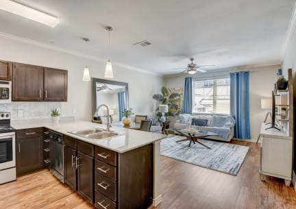 the view of a kitchen and living room with a large window