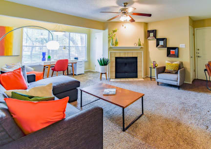 a living room with a couch coffee table and fireplace at Riverset Apartments, Memphis, 38103