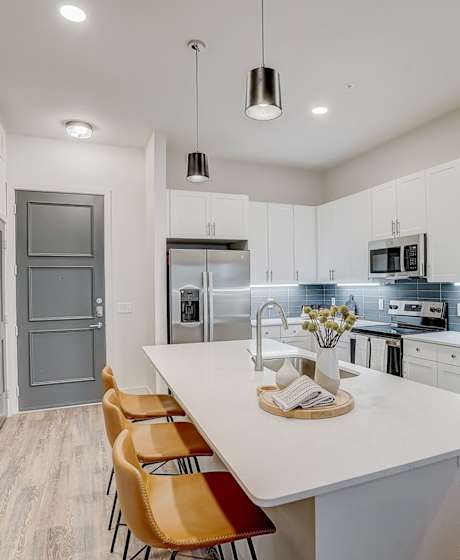 a kitchen with white cabinets and a white counter top