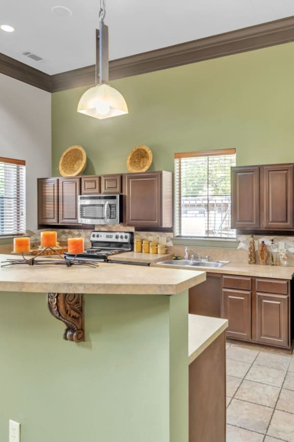 a kitchen with wooden cabinets and a black microwave