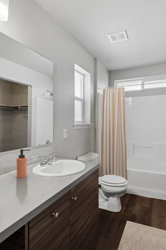 the bungalow bathroom has a large mirror and a shower and sink
