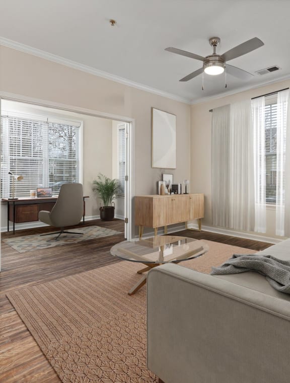a living room with a couch and a ceiling fan