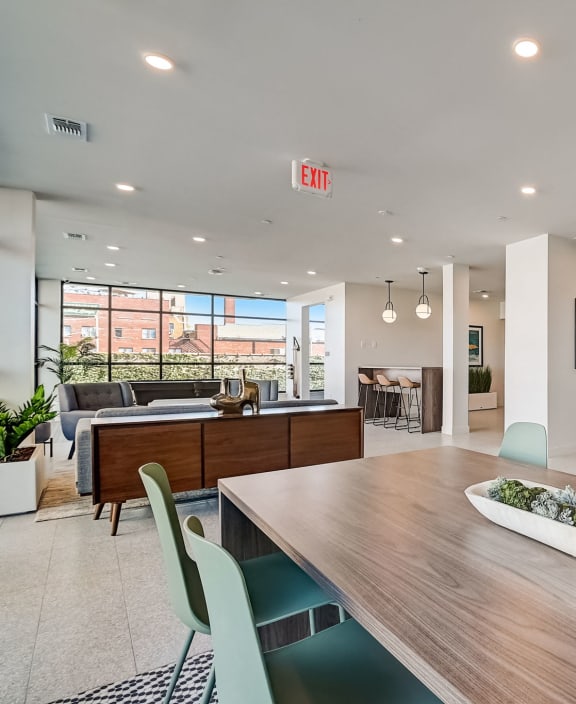 a dining room with a wooden table and chairs