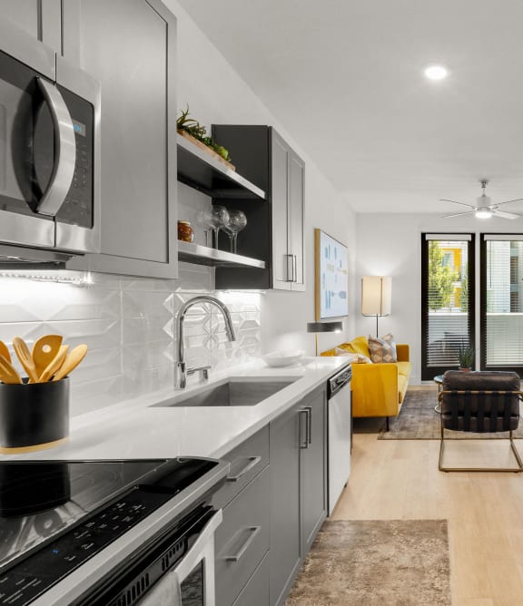 a kitchen with a large island with four blue chairs